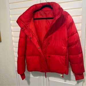BCBGeneration Vibrant Red puffer jacket with hood.